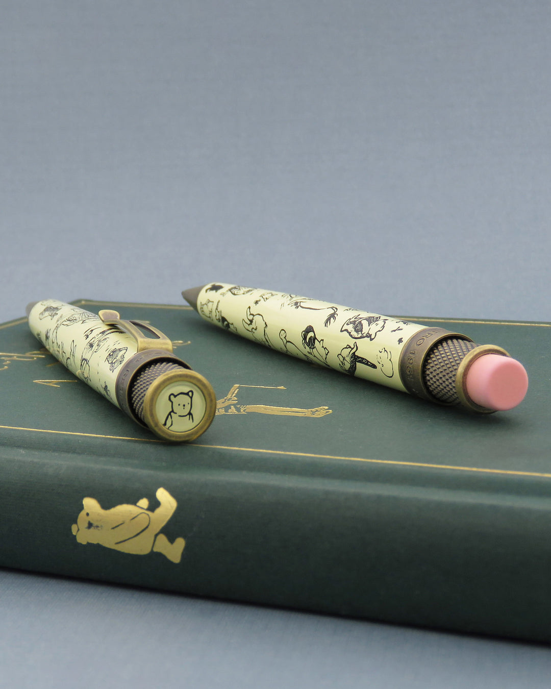 Winnie-the-Pooh decorations pen and pencil laying on top of book