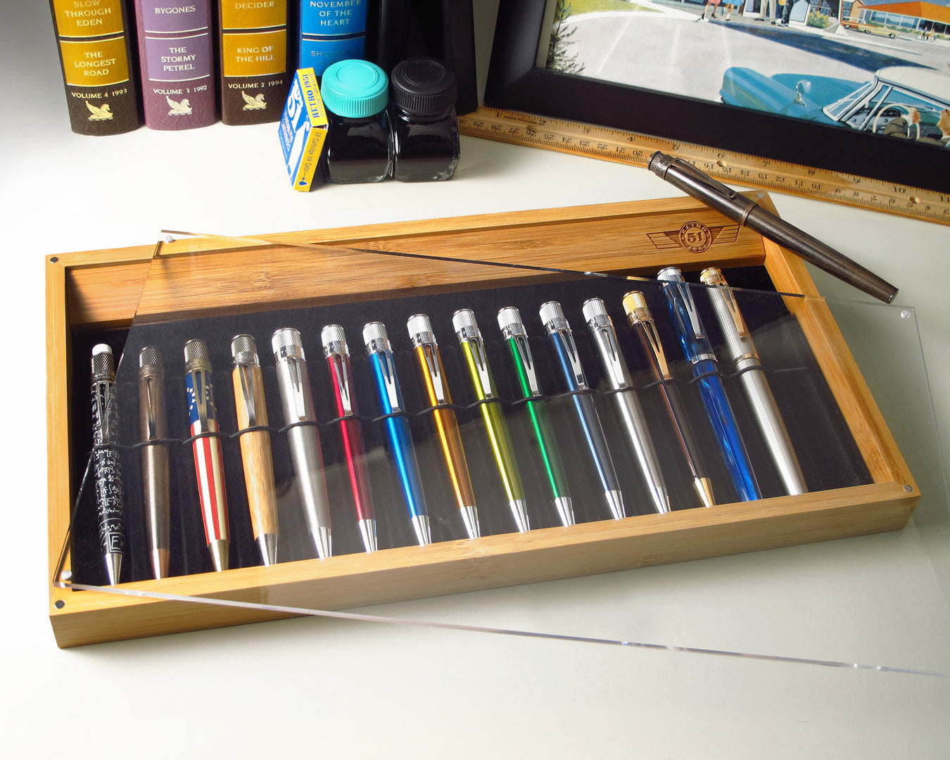 bamboo tray with assorted retro pens on a desk top 